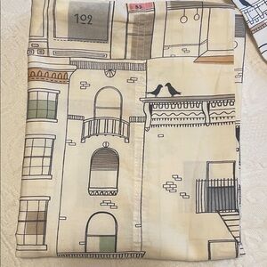 Two pillowcases with a unique city design.